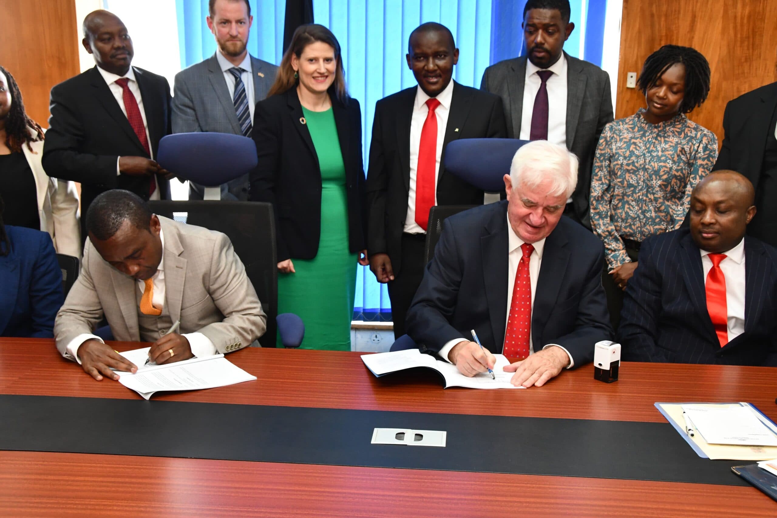 NIA CEO Eng Mwasia signing an agreement with British firm. Image: courtesy.