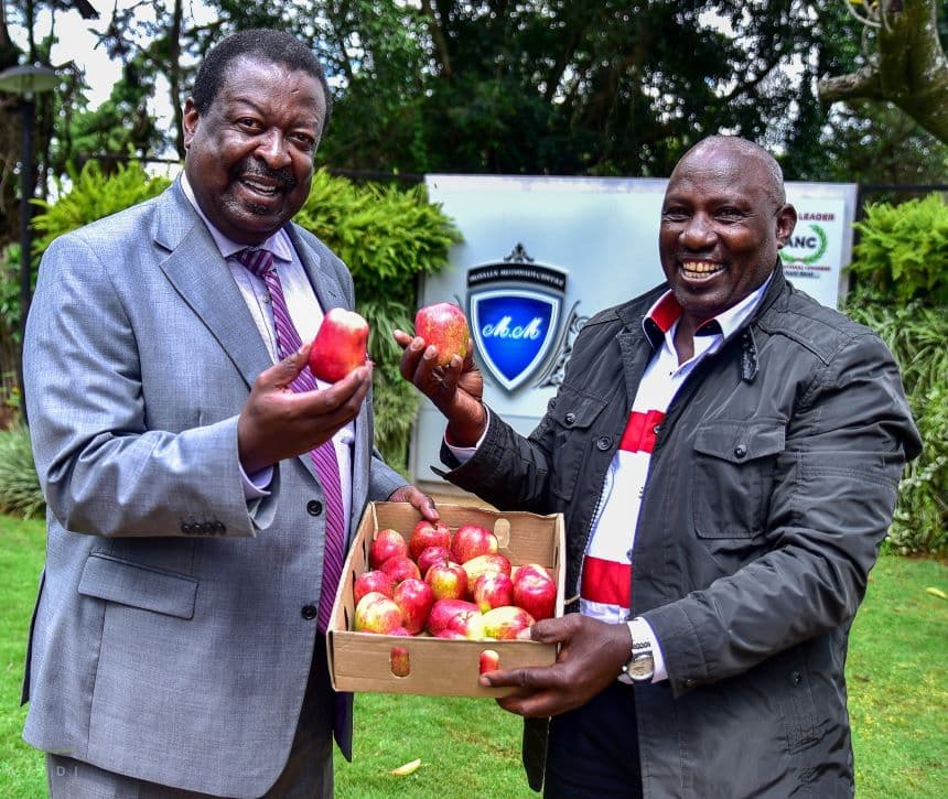 Prime CS Musalia Mudavaid with a director from Wambugu Apples. Image: courtesy.