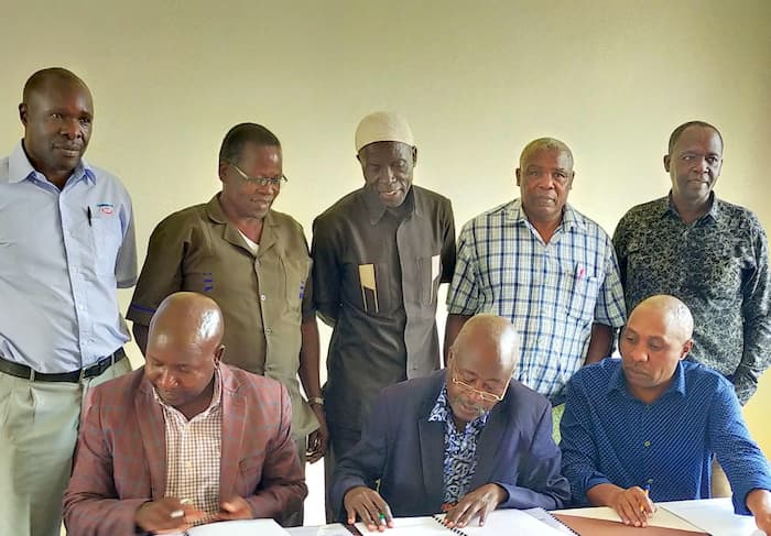 Chemuka Power Company Chairman, Robert Kipkemboi, KTDA Board Member representing Zone 12, Abungana Khasiani (middle), and Chemuka Vice-Chairman, Francis Wanjau during the signing of the agreement